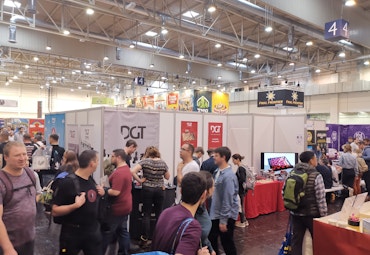 fair with people and red tables DGT logo